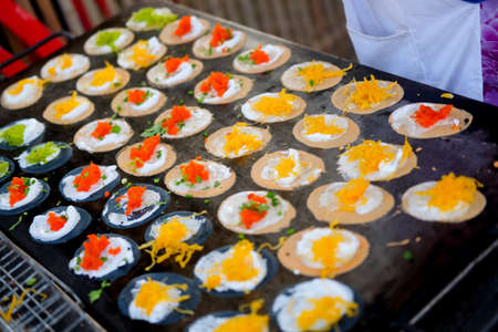 Thai people cooking ancient Indigenous called Thai sweetmeat Khanom bueang (a kind of filled pancake) at street marketの写真素材