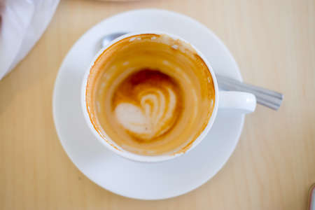 Empty hot coffee cup after drink on wood tableの写真素材