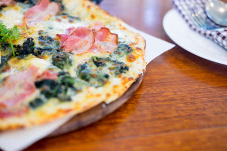 Spinach pizza with bacon on top. Healthy lifestyleの写真素材