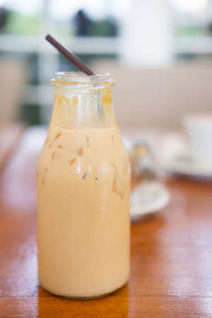 Ice coffee in tall glass with straws on tableの写真素材