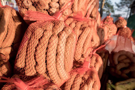 Sour and sweet tamarind in a red net bagの写真素材