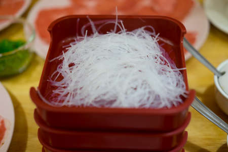 Vermicelli in red tray ingredients for hot potの写真素材