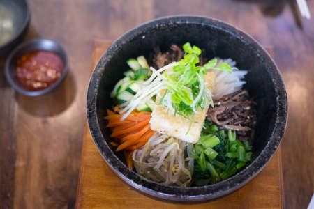 Bibimbap in a heated stone bowl korean style cuisine hot and deliciousの写真素材