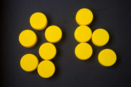 Stack of recyclable yellow plastic bottle capsの写真素材