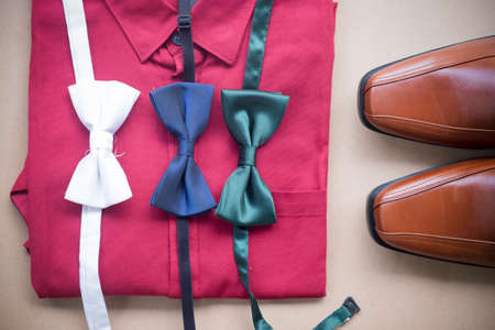 Flat lay set of male clothes and accessories on brown backgroundの写真素材