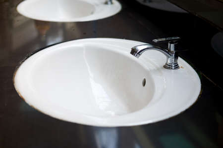 Water tap in modern public bathroom