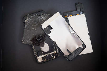 Broken smartphone on black box preparing for recycling and disposalの写真素材