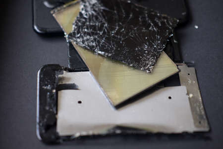 Broken panels and screens phones lie in the service and are preparing for recycling and disposalの写真素材
