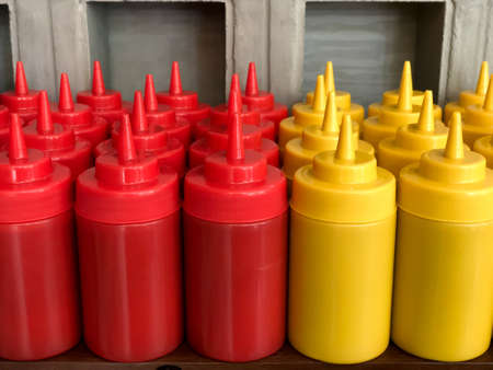 Stock of ketchup and mustard bottles at a restaurantの写真素材