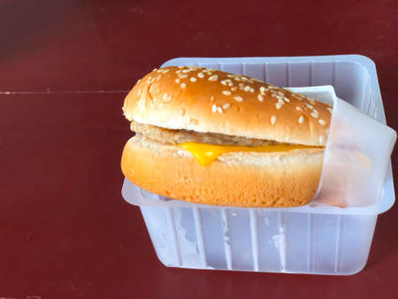 Hamburger in the plastic box on wood tabelの写真素材