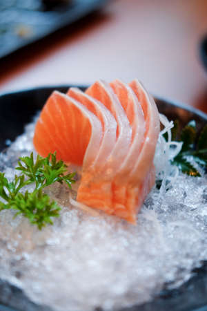 Raw salmon slice or salmon sashimi in Japanese style fresh serve on ice in bowl.の写真素材