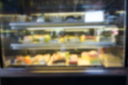 Blurred background of variety of cakes in showcaseの写真素材