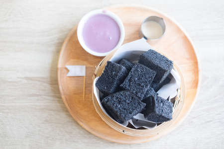 Activated charcoal steamed bread and pandan custard in restaurant Thai dessertの写真素材