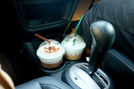 The driver and ice coffee in the personal car. (two glass)