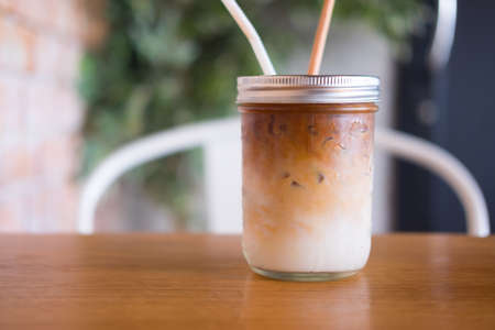 Iced coffee in glass on table in cafe or restaurant Lifestyle conceptの写真素材