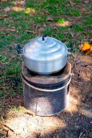 Steaming pot on charcoal stove, outdoor kitchen