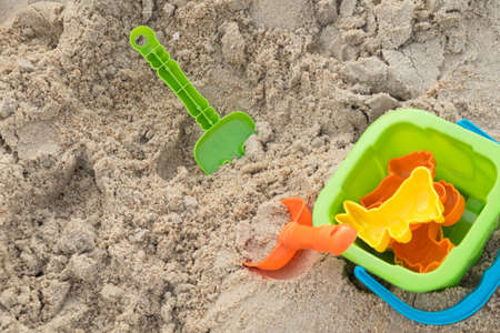 Close up of plastic beach toys on the beachの写真素材