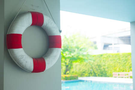 Life ring hanging at the swimming pool as rescue equipment