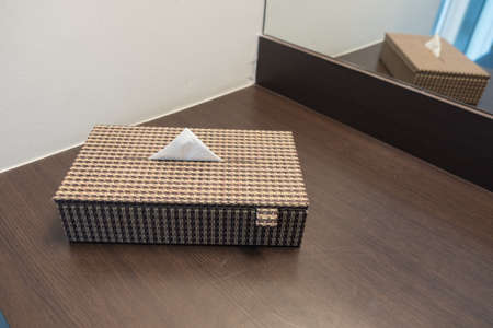 Tissue in the wooden wicker box on dressing tableの写真素材