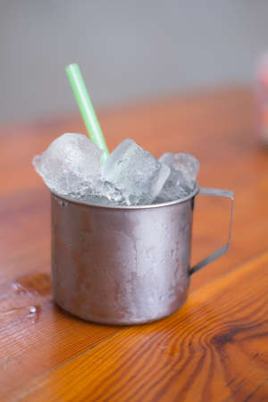 Empty ice in aluminium mug for drink in Thai restaurant (popular for street food in Thailand)の写真素材