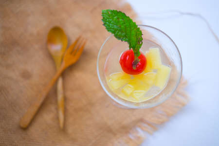Glasses of pineapple juice with cherry and mint. healthy drink concept.