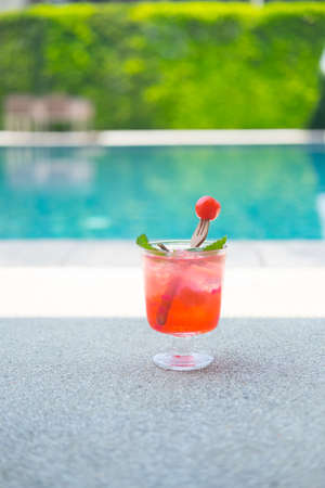 Close up cherry lemon soda or cherry mojito in clear glass on poolの写真素材
