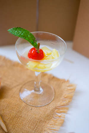Glasses of pineapple juice with cherry and mint. healthy drink concept.