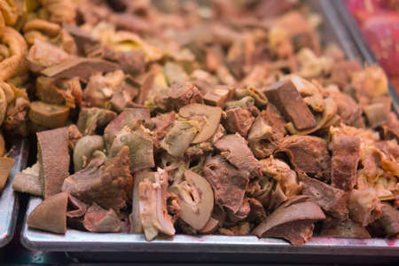 Uncooked entrails on tray for sale in marketの写真素材