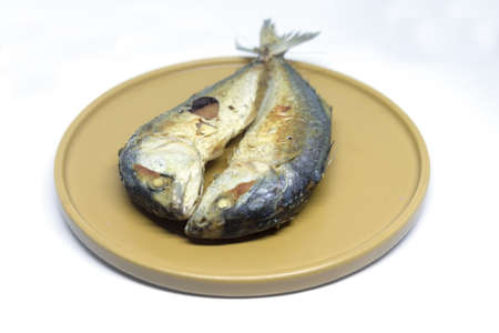 Fried mackerel in yellow plate, Thai food.の写真素材