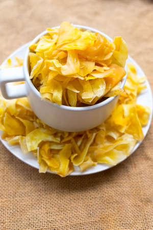 Jackfruit chips in white bowl, Thai snack style
