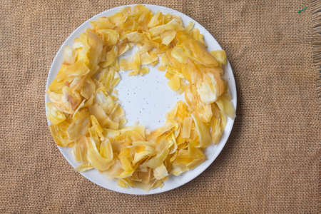 Fried sliced jackfruit in white dish, top view