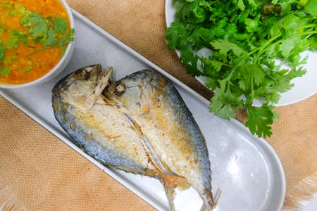 Fried mackerel with spicy shrimp paste chili sauce and vegetableの写真素材