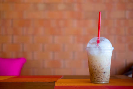 Espresso Iced coffee with straws in plastic clear cup, summer drinkの写真素材