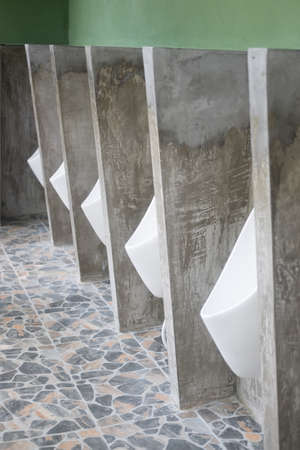 White ceramic urinals for men in the toilet room, public men toilet roomの写真素材