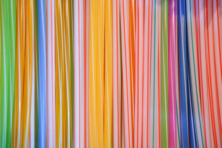 Vibrant background of multicolored plastic straws for cocktailsの写真素材