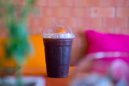 Cold black coffee with ice on wood table in coffee shopの写真素材