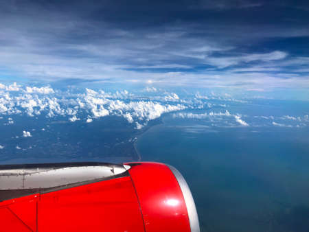 View from plane window on engine and land. Beautiful blue skyの写真素材
