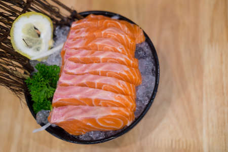 Raw salmon slice or salmon sashimi in Japanese style fresh serve on ice in bowl.の写真素材