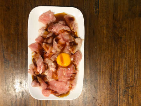 Raw fresh pork sliced with yolk egg prepare for cooking hot pot