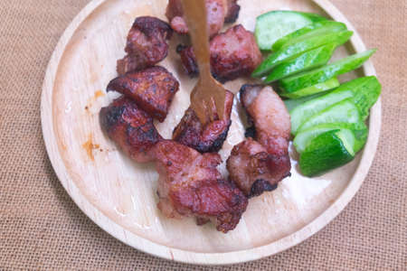 Fried pork rib served with cucumber this menu looks appetizing