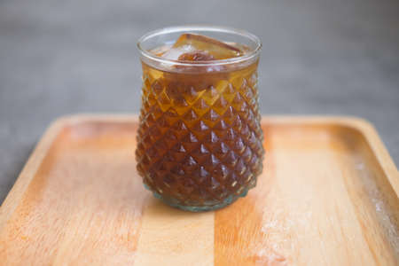 Longan juice with ice in glass on wood trayの写真素材