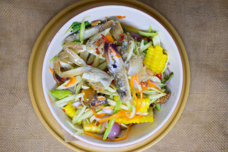 Spicy mango salad with fresh blue crab, Thai hot and spicy appetizerの写真素材