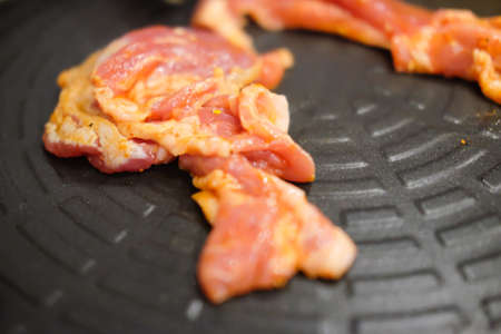 Roasted korean meat on korean stove in restaurant (fresh meat)の写真素材