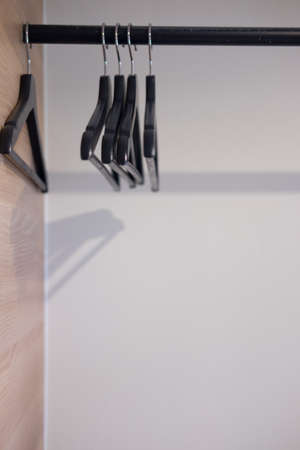 Rack of clothes with empty plastic hangers