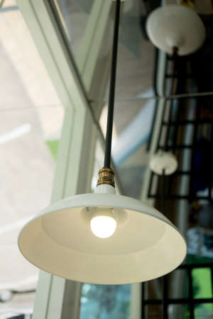 Hanging lamps under the ceiling. Decorative lines of white lamps