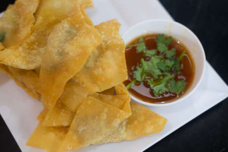 The fried dumplings on plate and sauce on white dishの写真素材