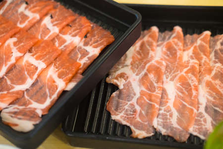 Raw beef or sliced beef on black trayの写真素材