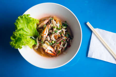 Noodles seafood Tom yum with crab in a bowl Thai style food.の写真素材