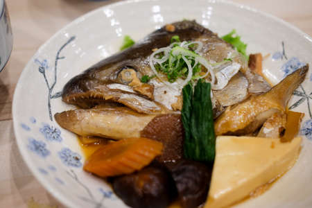 Delicious salmon head boiled with soy sauce in Japanese style dish