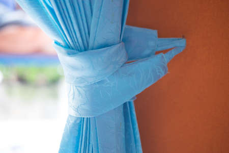 Part of beautifully draped curtain on the window in the roomの写真素材